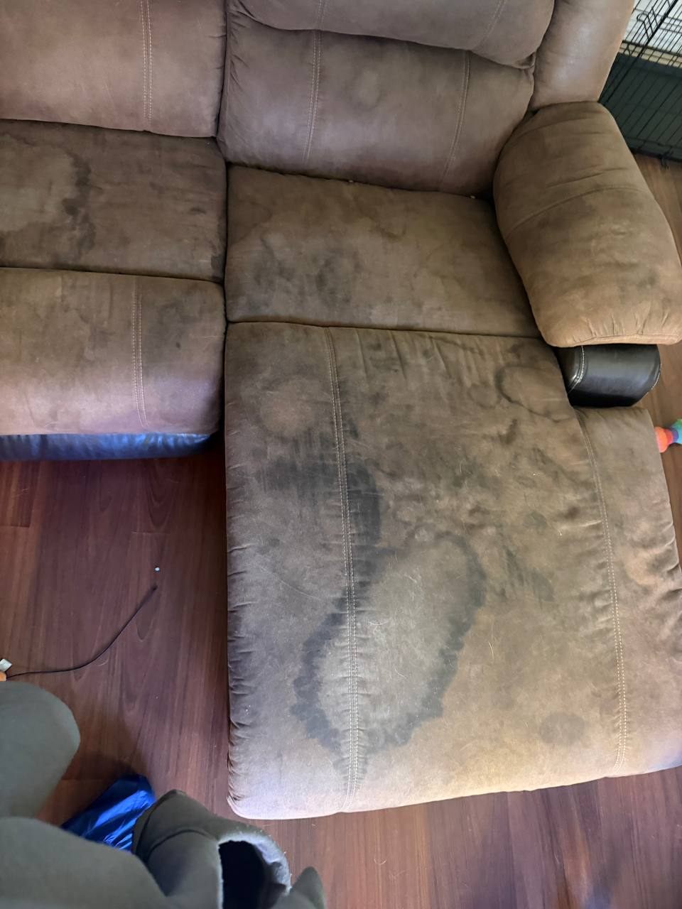Before upholstery cleaning on a sectional chaise with heavy visible staining