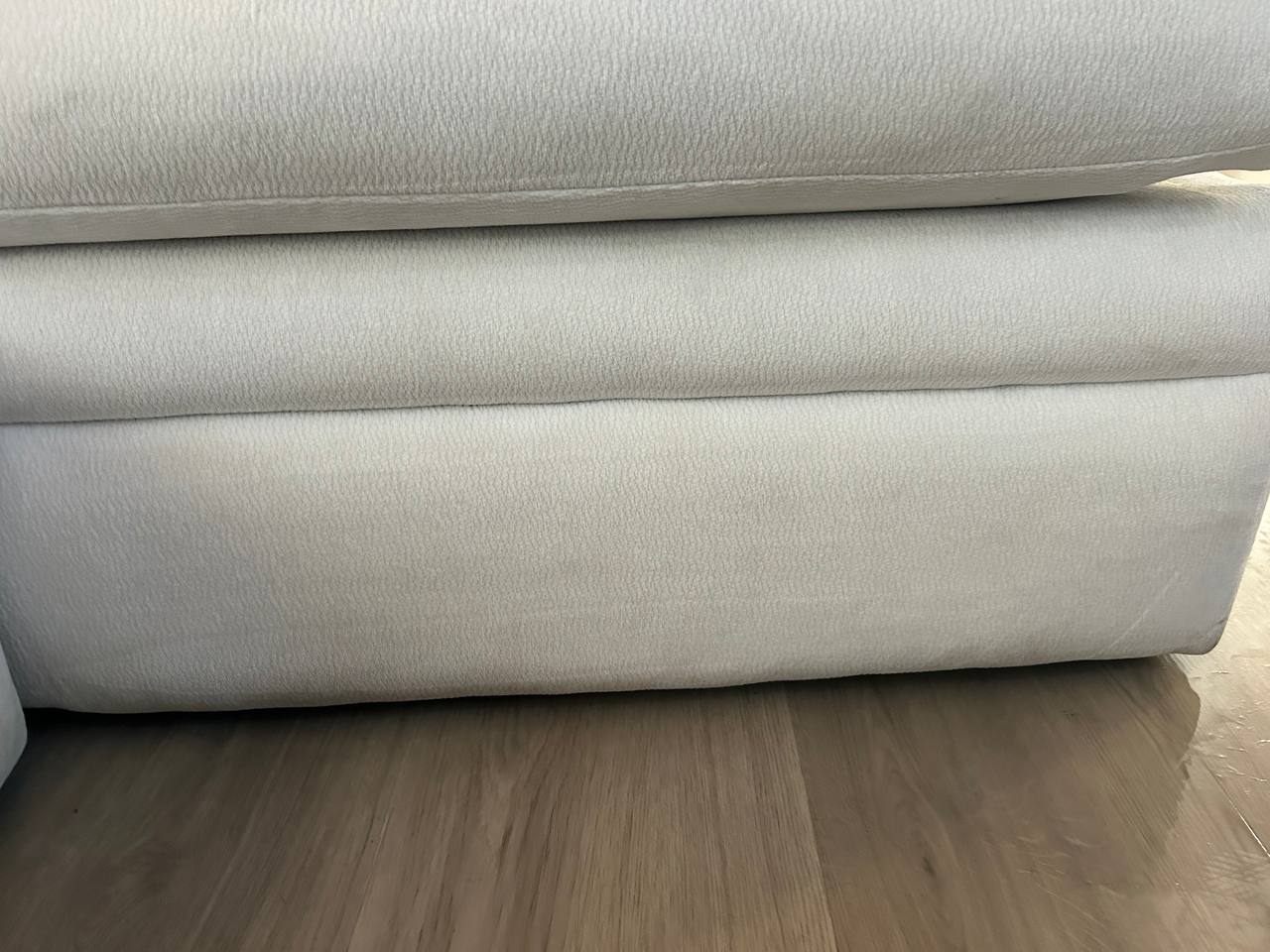 After upholstery cleaning on a light sofa base with the dark stain removed