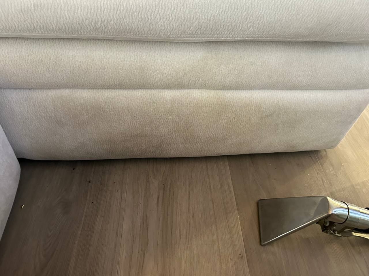 Before upholstery cleaning on a light sofa base with a dark visible stain